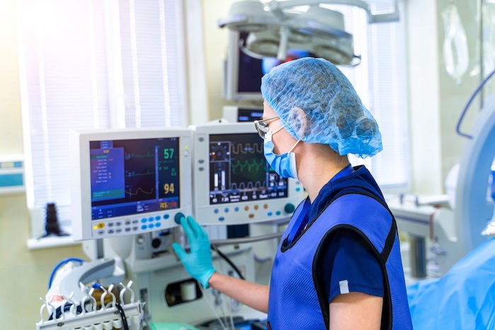 Nurse in hospital using medical device management software