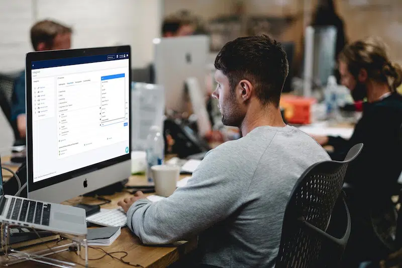 A man on a computer using free inventory management software