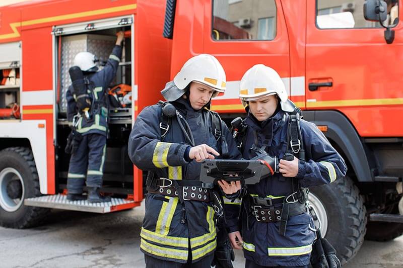 Employee accessing vehicle scheduling software on a tablet for real-time fleet updates