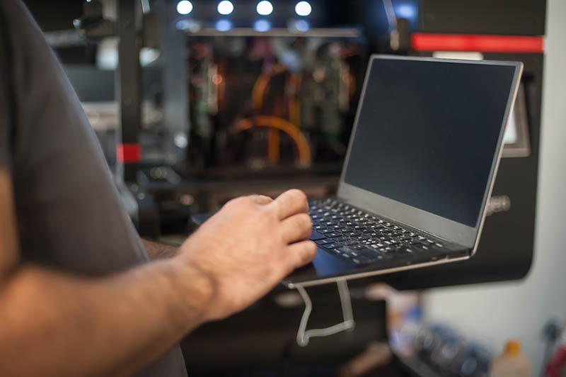 Person on laptop using it to get to the dashboard from deadline management software