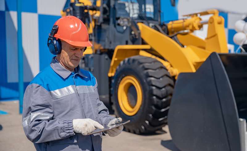 Employee using an equipment management app on a tablet