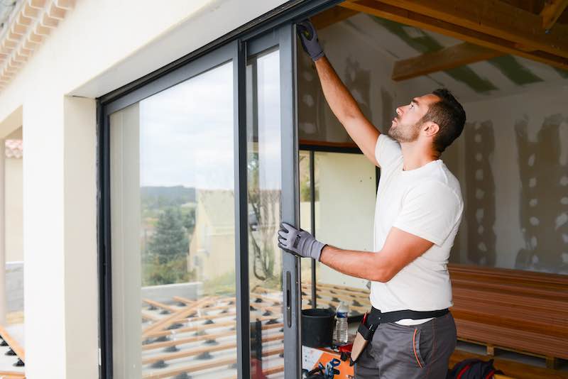 Man on a construction site checking tool details with an equipment management app