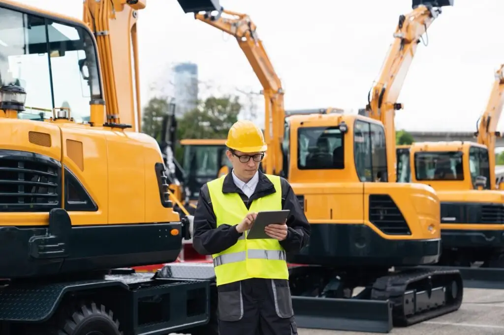 Engineer,In,A,Helmet,With,A,Digital,Tablet,Stands,Next
