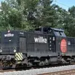 Locomotora ferroviaria negra con el logo de Willke, lista en la vía para operaciones.﻿