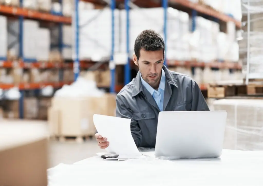 Warehouse employee looks at inventory numbers